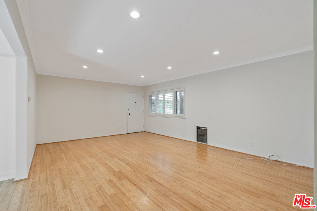 2030 North Vermont Avenue, Unit 6 Los Angeles, CA 90027 - Photo 6 of 25 a view of an empty room with wooden floor and a window