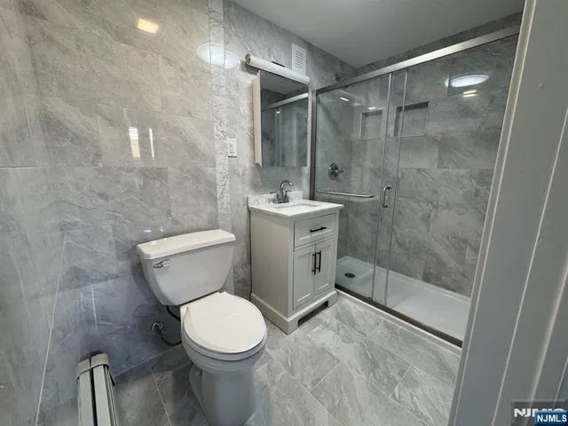 a bathroom with a toilet sink and shower