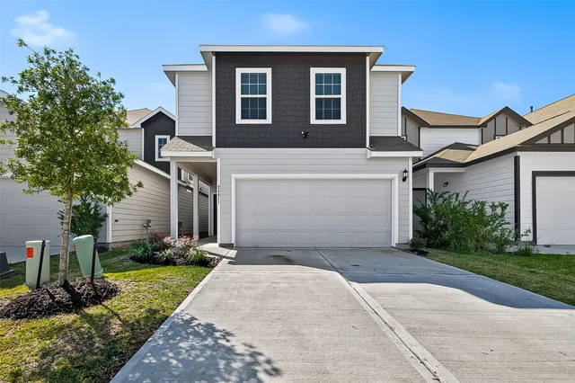 a front view of a house with a yard and garage