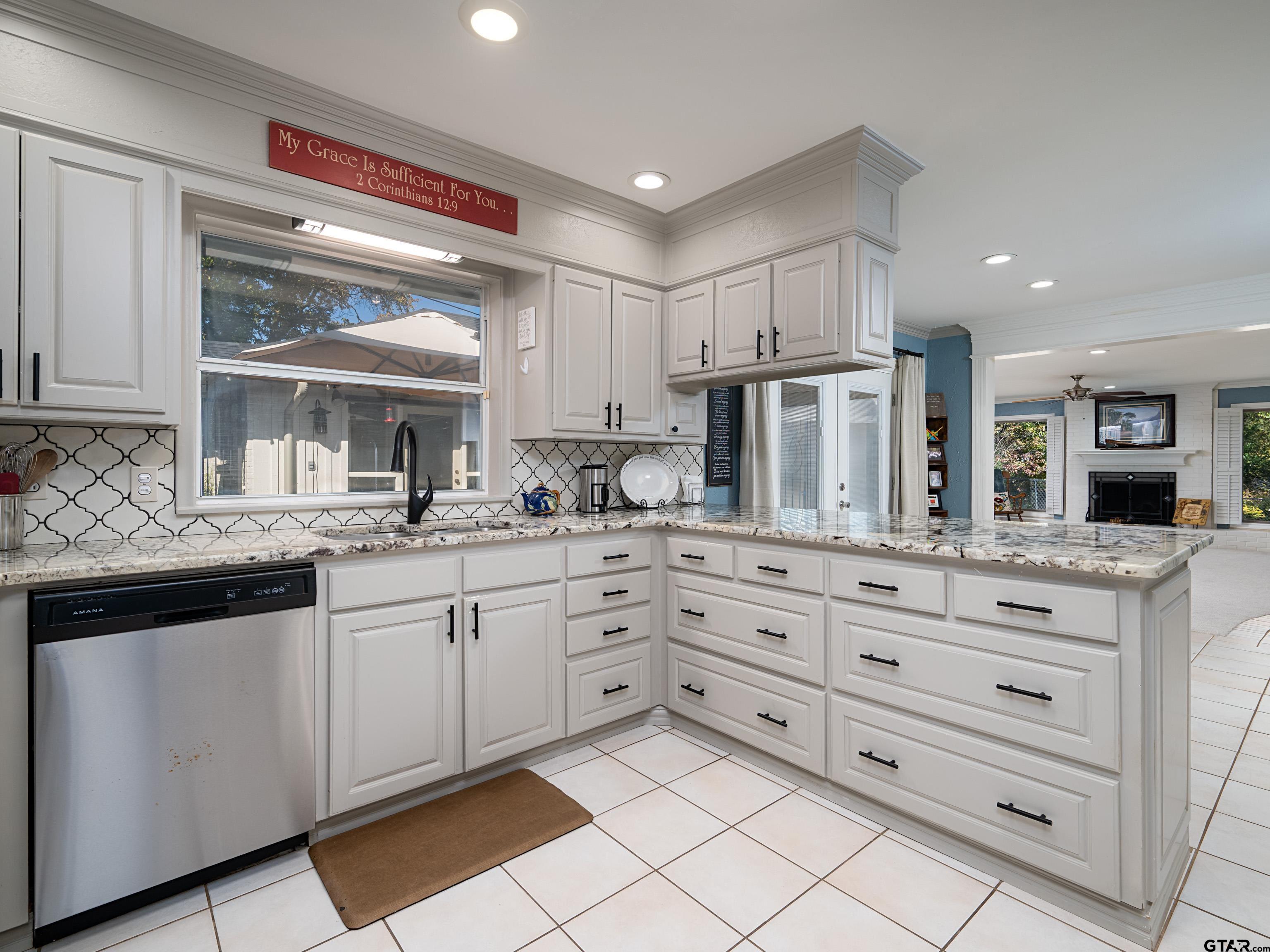 8212 Cambridge Road Tyler, TX 75703 - Photo 12 of 44 a kitchen with granite countertop white cabinets and white stainless steel appliances