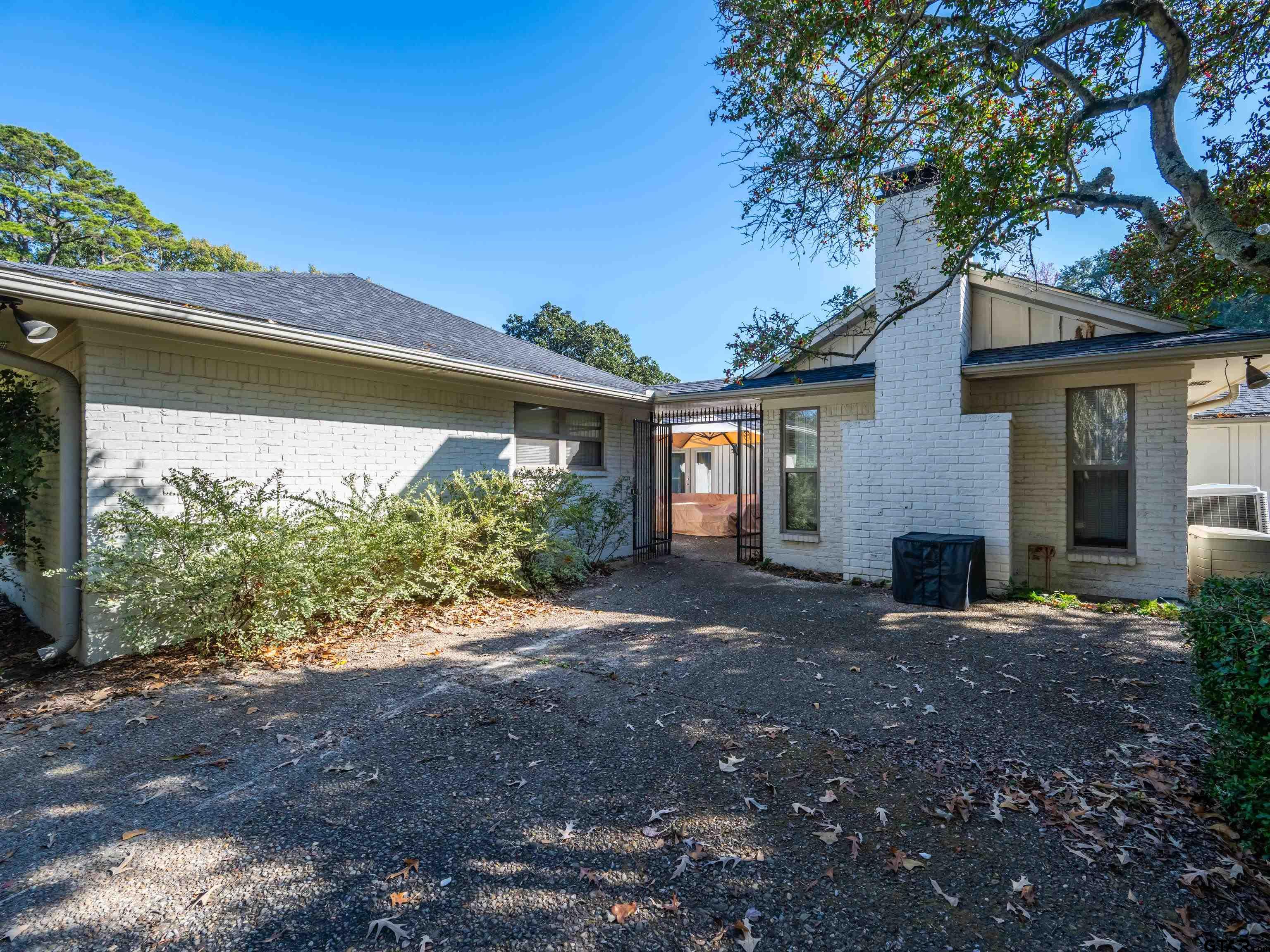 8212 Cambridge Road Tyler, TX 75703 - Photo 34 of 44 a view of a house with yard and a tree