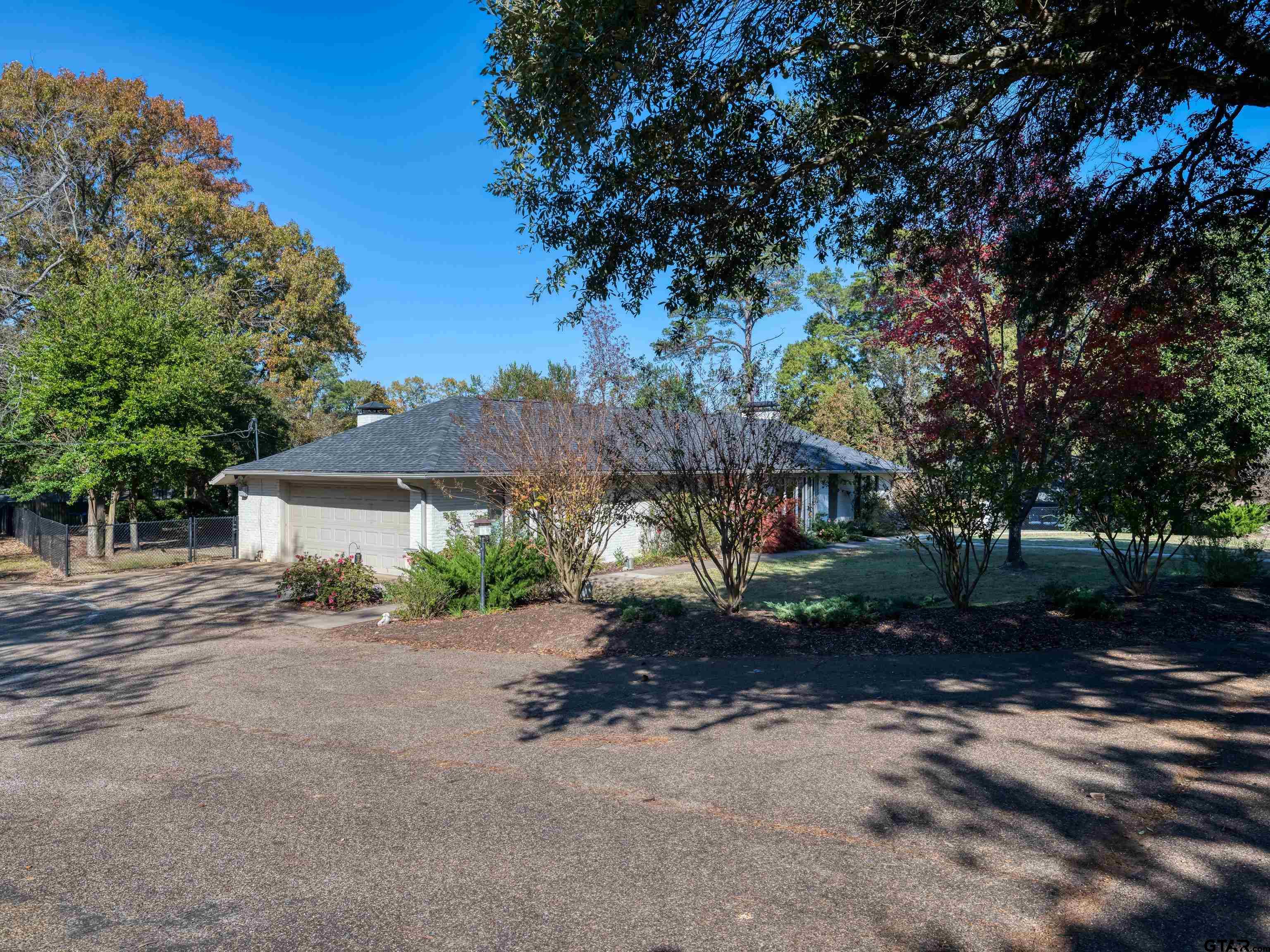 8212 Cambridge Road Tyler, TX 75703 - Photo 4 of 44 a view of a house with a tree in the background