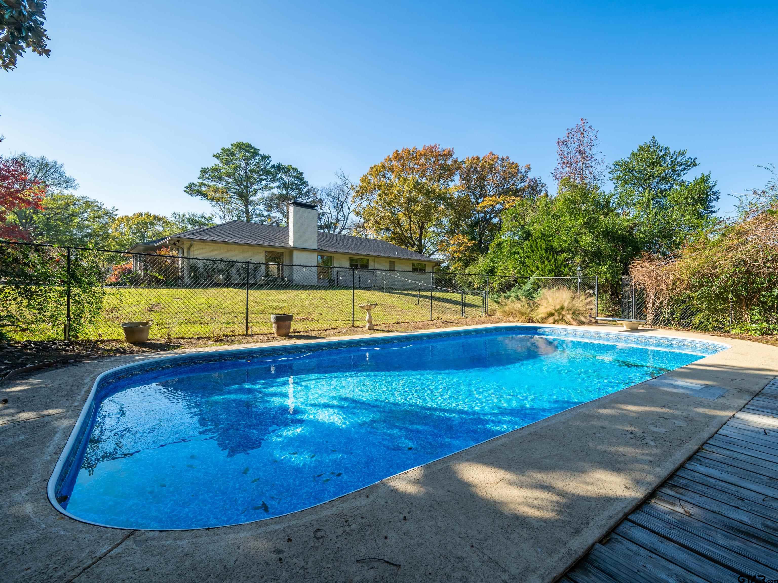 8212 Cambridge Road Tyler, TX 75703 - Photo 41 of 44 a view of a swimming pool with an outdoor space and seating area