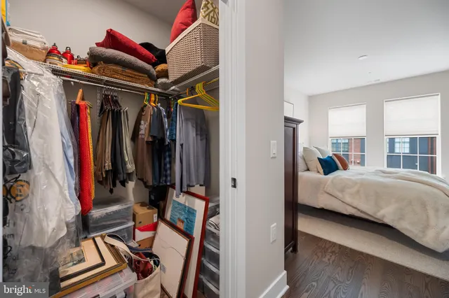 a view of walk in closet with clothes and shoes