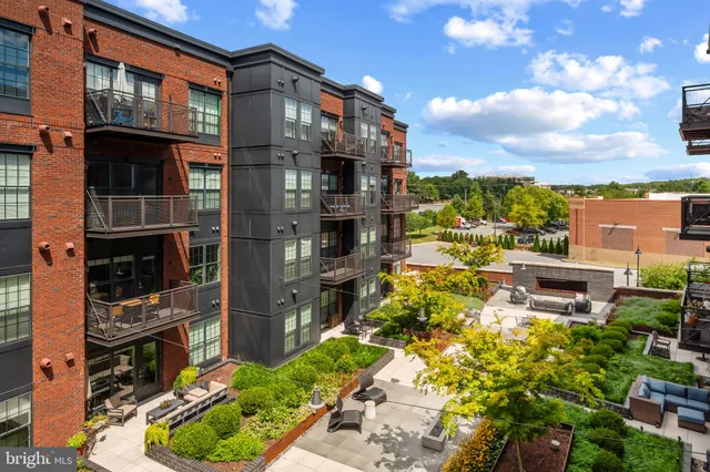 a view of a patio with couches table and chairs and potted plants
