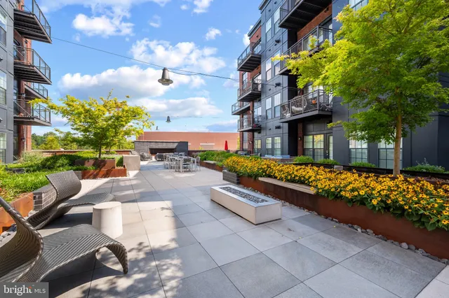 a view of outdoor sitting area with furniture and a fire pit