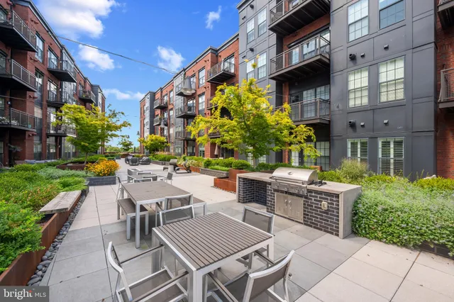a view of a patio with couches table and chairs and potted plants