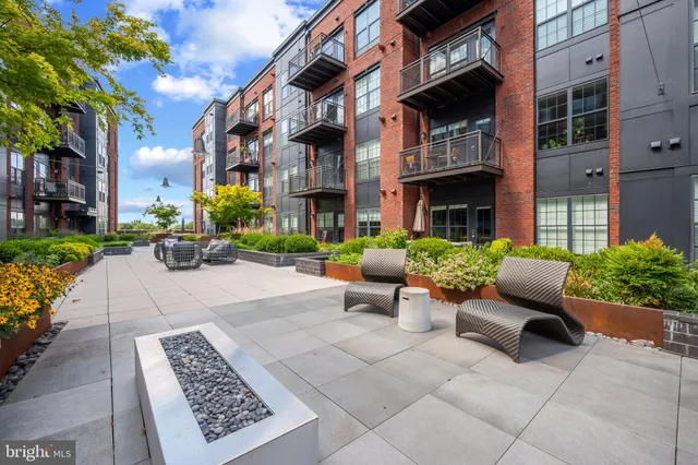 a front view of a brick building with a yard