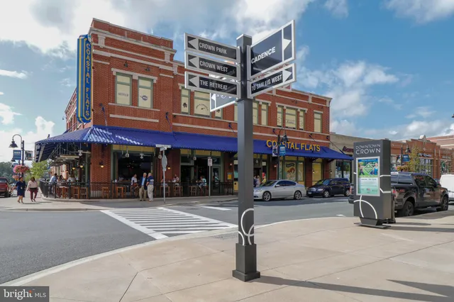 a view of a street with potted plants