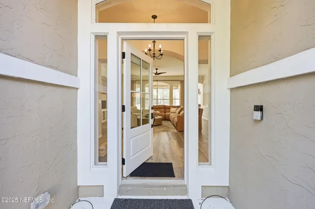 a view of a dining room and livingroom with furniture wooden floor a rug a fireplace