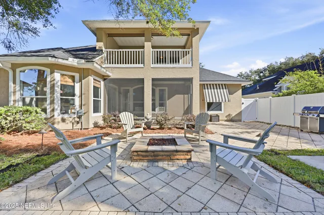 a front view of a house with garden and outdoor seating
