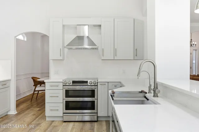 a view of a porch with chairs and backyard of the house