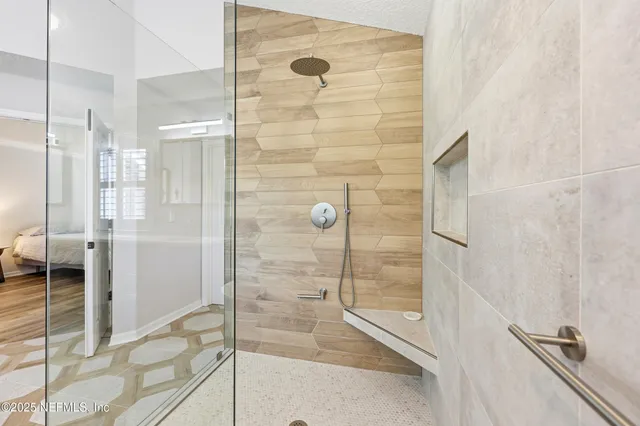 a view of a swimming pool with lawn chairs under an umbrella