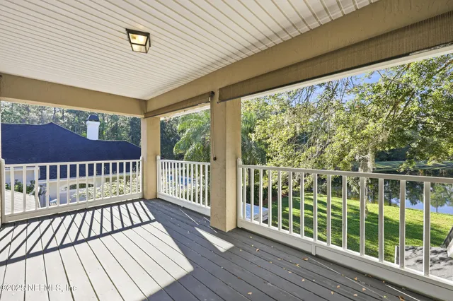 a living room with furniture a fireplace and a floor to ceiling window