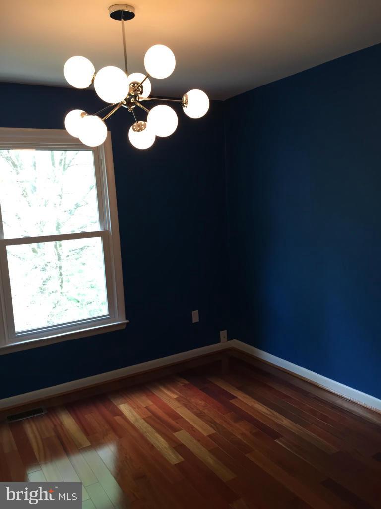 9042 Saffron Lane Silver Spring, MD 20901 - Photo 18 of 21 a view of a room with wooden floor and a window