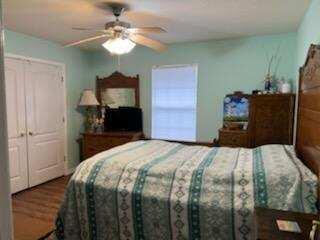 482 Driftwood Point Road Santa Rosa Beach, FL 32459 - Photo 21 of 40 a bedroom with a bed and a chandelier
