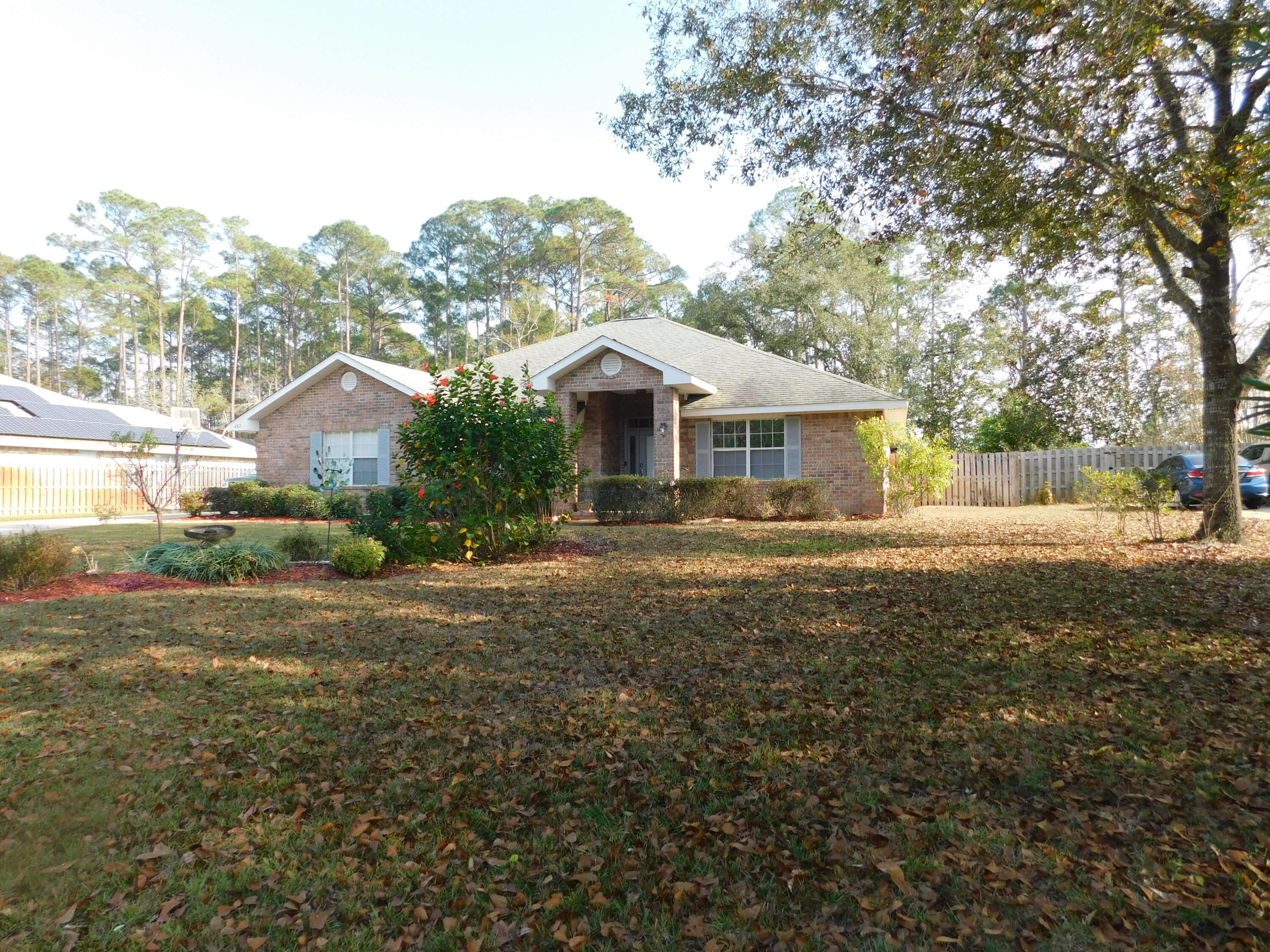 482 Driftwood Point Road Santa Rosa Beach, FL 32459 - Photo 35 of 40 a front view of a house with a garden