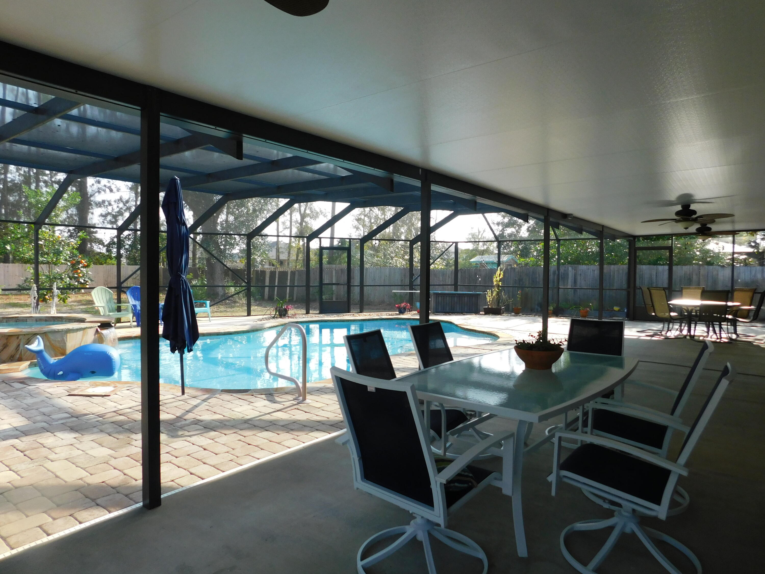 482 Driftwood Point Road Santa Rosa Beach, FL 32459 - Photo 38 of 40 a view of a patio with a table chairs and a backyard