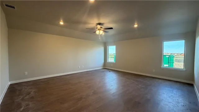 a view of a kitchen with refrigerator and white cabinets