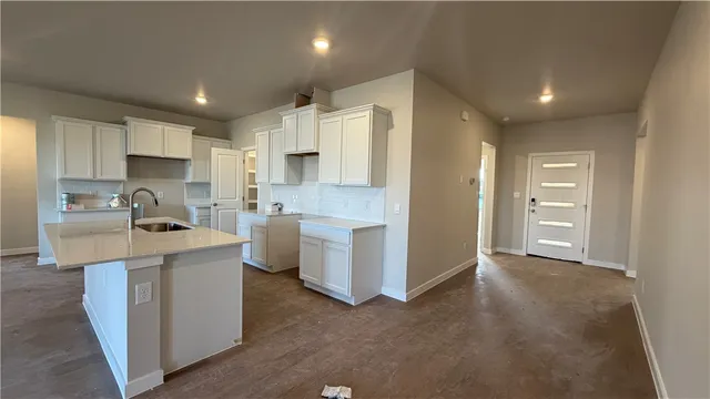 a kitchen with a sink cabinets stainless steel appliances and a window