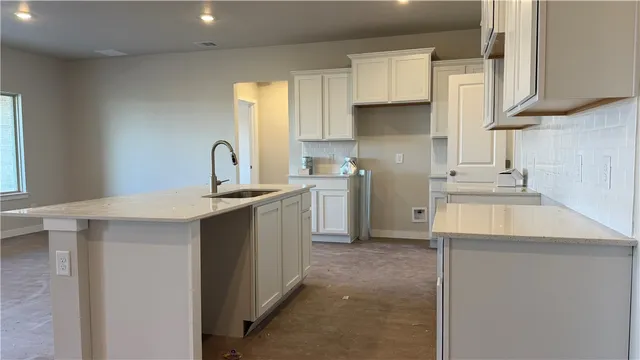 a kitchen with cabinets a sink and appliances