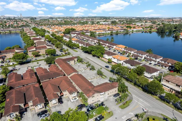 an aerial view of residential building and lake