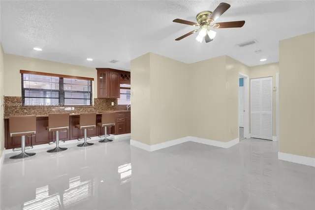 a kitchen with a sink cabinets and window