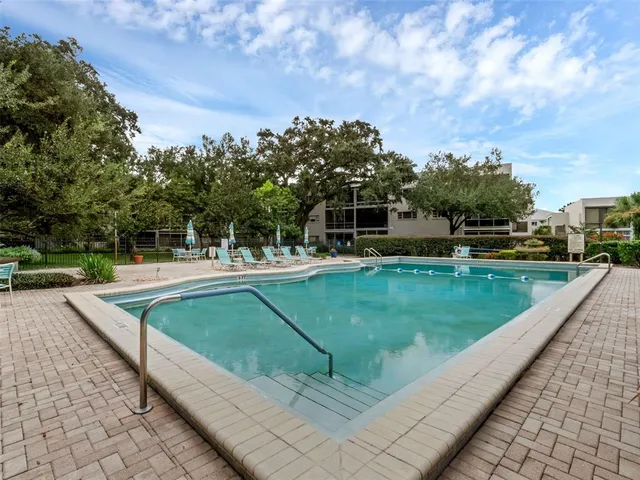 a swimming pool view with a seating space