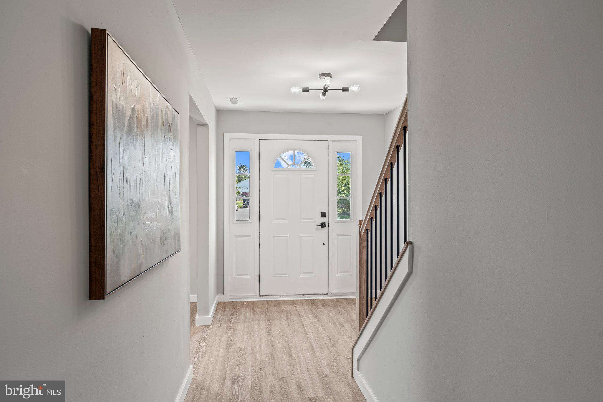 71 Borrelly Boulevard Sewell, NJ 08080 - Photo 15 of 39 a view of a hallway with wooden floor and staircase