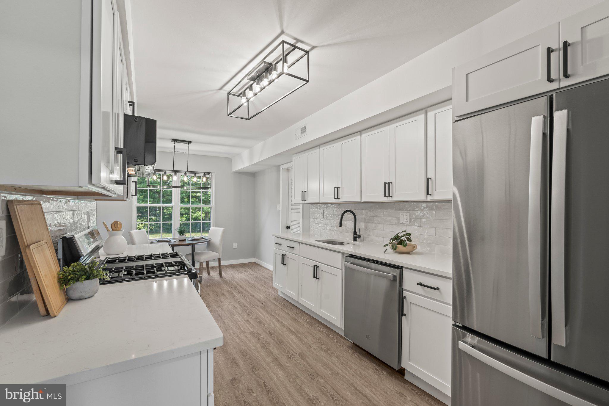 71 Borrelly Boulevard Sewell, NJ 08080 - Photo 7 of 39 a kitchen with granite countertop a sink stainless steel appliances and cabinets