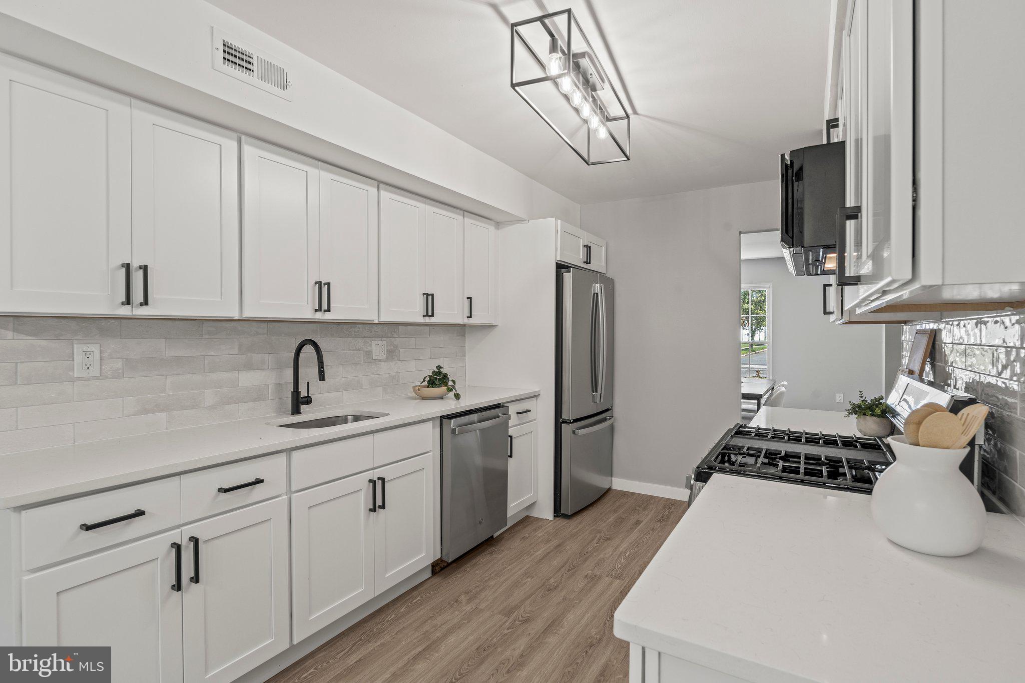 71 Borrelly Boulevard Sewell, NJ 08080 - Photo 9 of 39 a kitchen with stainless steel appliances a sink stove and refrigerator