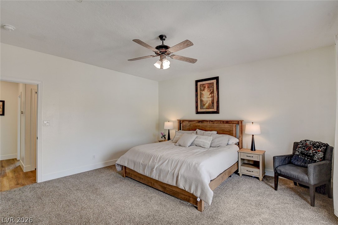 4362 Thistle Street Logandale, NV 89021 - Photo 27 of 99 A tranquil sleeping chamber complemented by soft carpeting and a ceiling fan for comfort.