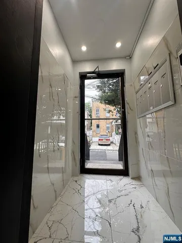 a view of entryway with a floor to ceiling window and outdoor view