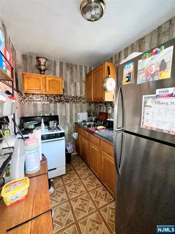 a kitchen with refrigerator and window