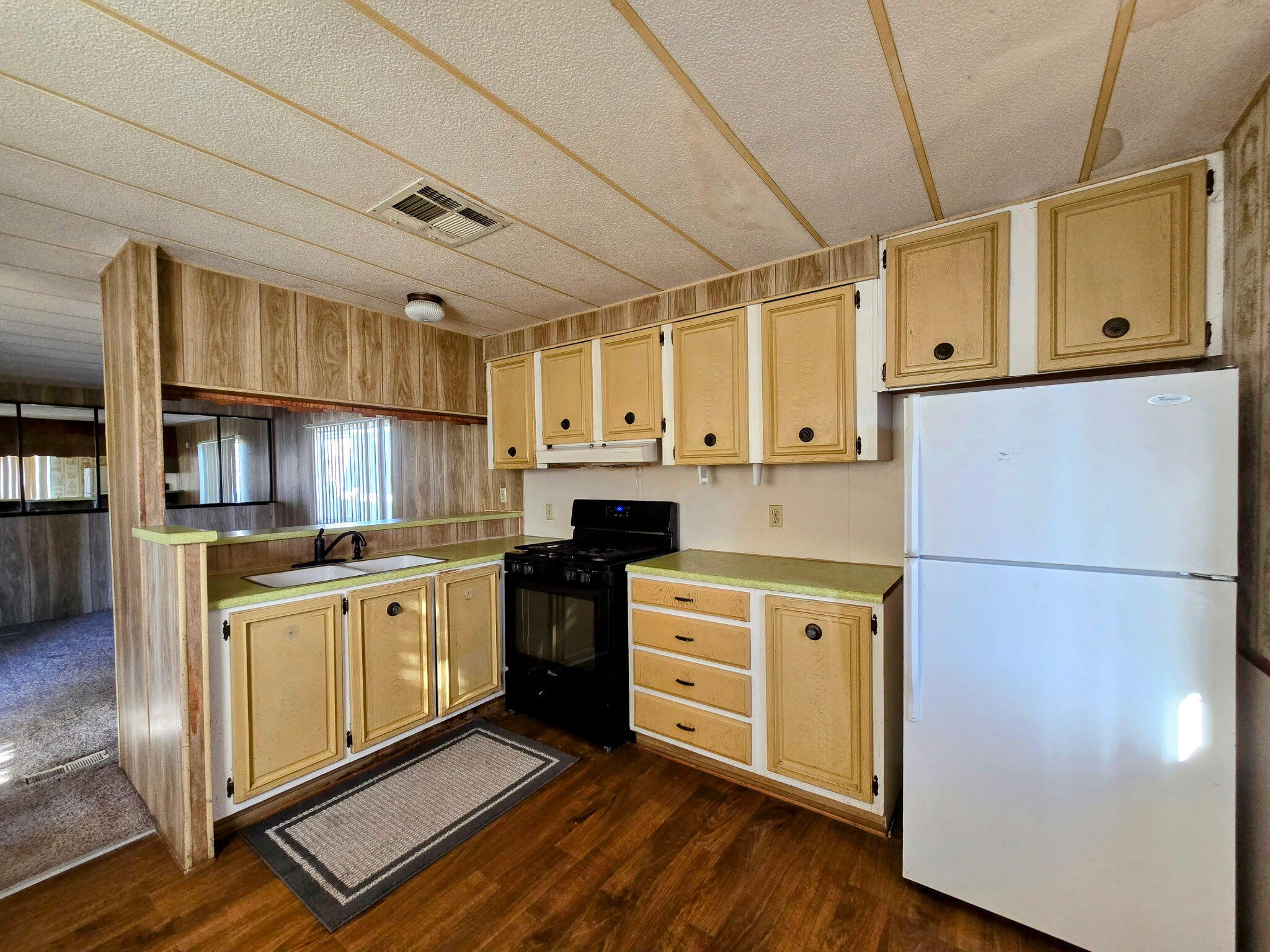 34220 Cheseboro Road Palmdale, CA 93552 - Photo 2 of 12 a kitchen with stainless steel appliances a refrigerator sink and cabinets