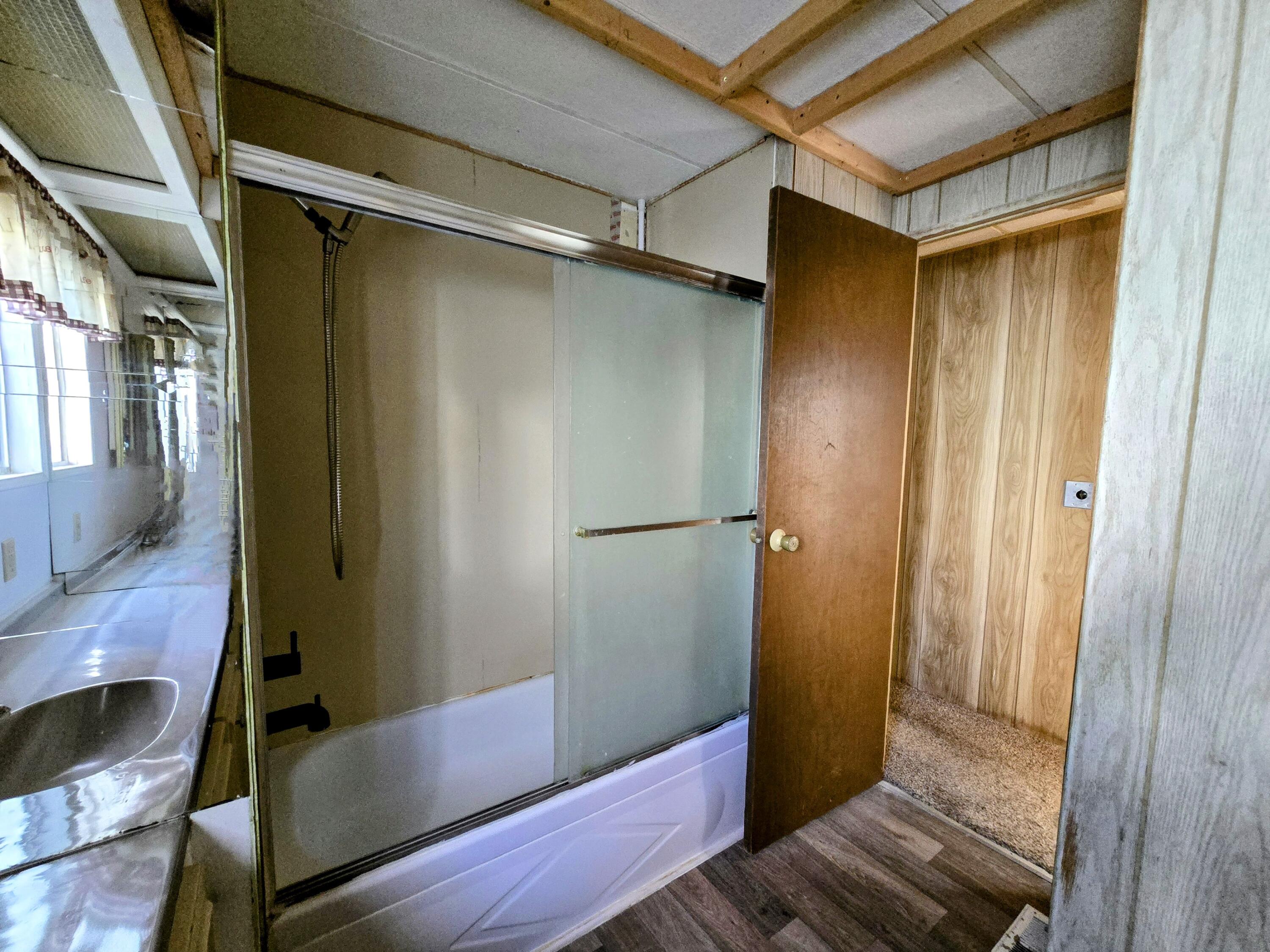 34220 Cheseboro Road Palmdale, CA 93552 - Photo 4 of 12 a bathroom with a bathtub and shower