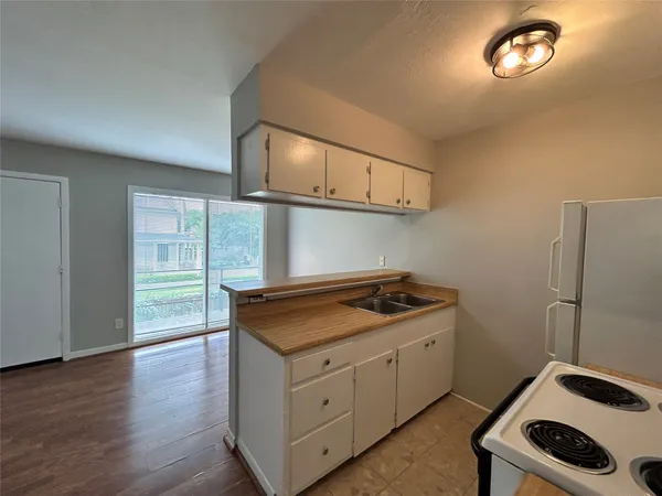 a kitchen with cabinets and a stove top oven