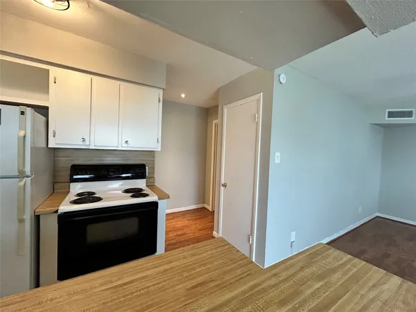 a kitchen with a stove and a refrigerator
