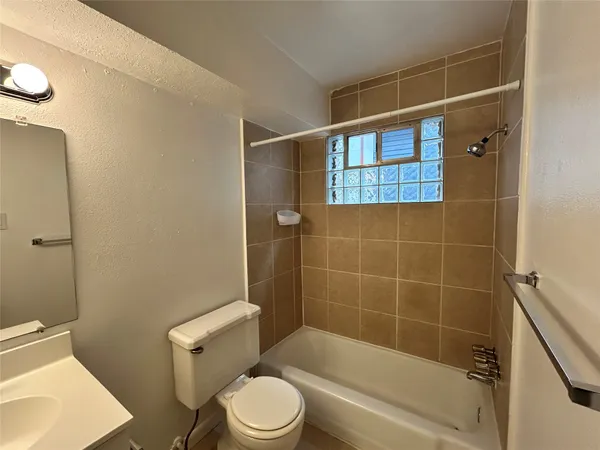 a bathroom with a toilet and shower