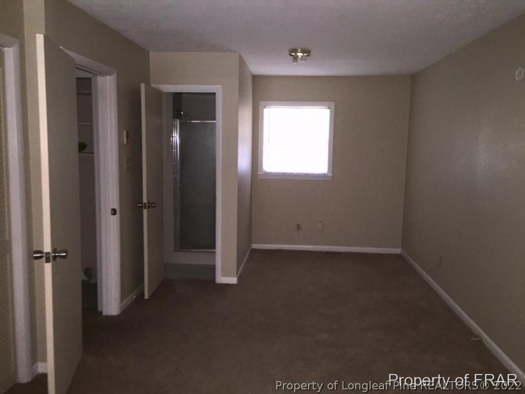 1413 Hibiscus Road Fayetteville, NC 28311 - Photo 4 of 10 an empty room that has a window in it