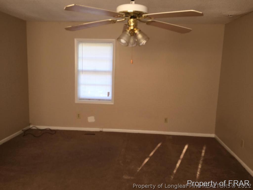 1413 Hibiscus Road Fayetteville, NC 28311 - Photo 6 of 10 a view of an empty room with a window