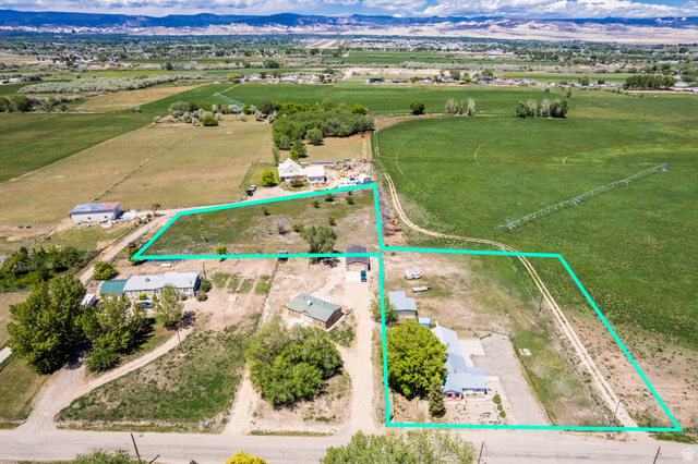 1043 East 4000th Street South Vernal, UT 84078 - Photo 31 of 31 Aerial perspective showcasing multiple parcels outlined in green, surrounded by expansive green agricultural fields