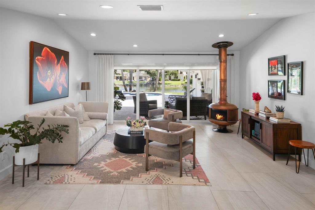 a living room with furniture a large window with table and chairs