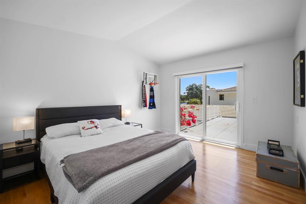 3161 North 36th Street Hollywood, FL 33021 - Photo 30 of 70 a bedroom with a bed and wooden floor