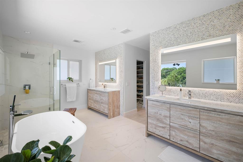 3161 North 36th Street Hollywood, FL 33021 - Photo 43 of 70 a bathroom with a granite countertop tub a sink and a large mirror