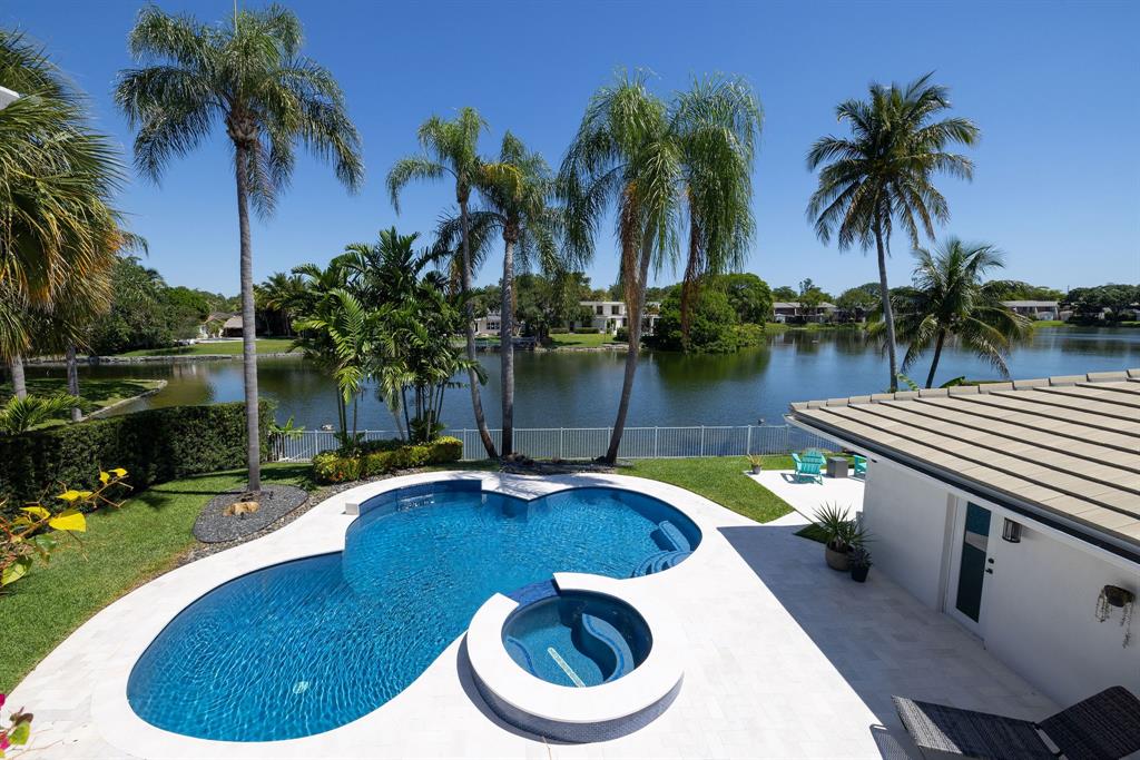 3161 North 36th Street Hollywood, FL 33021 - Photo 60 of 70 a view of a swimming pool with a patio and a garden