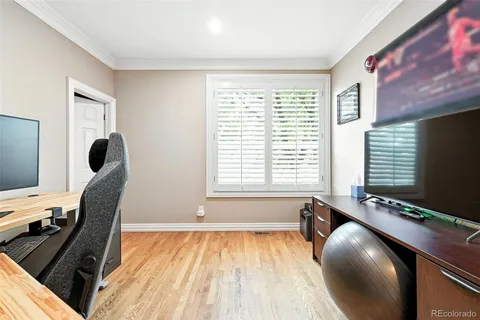 a view of a workspace with furniture and a window