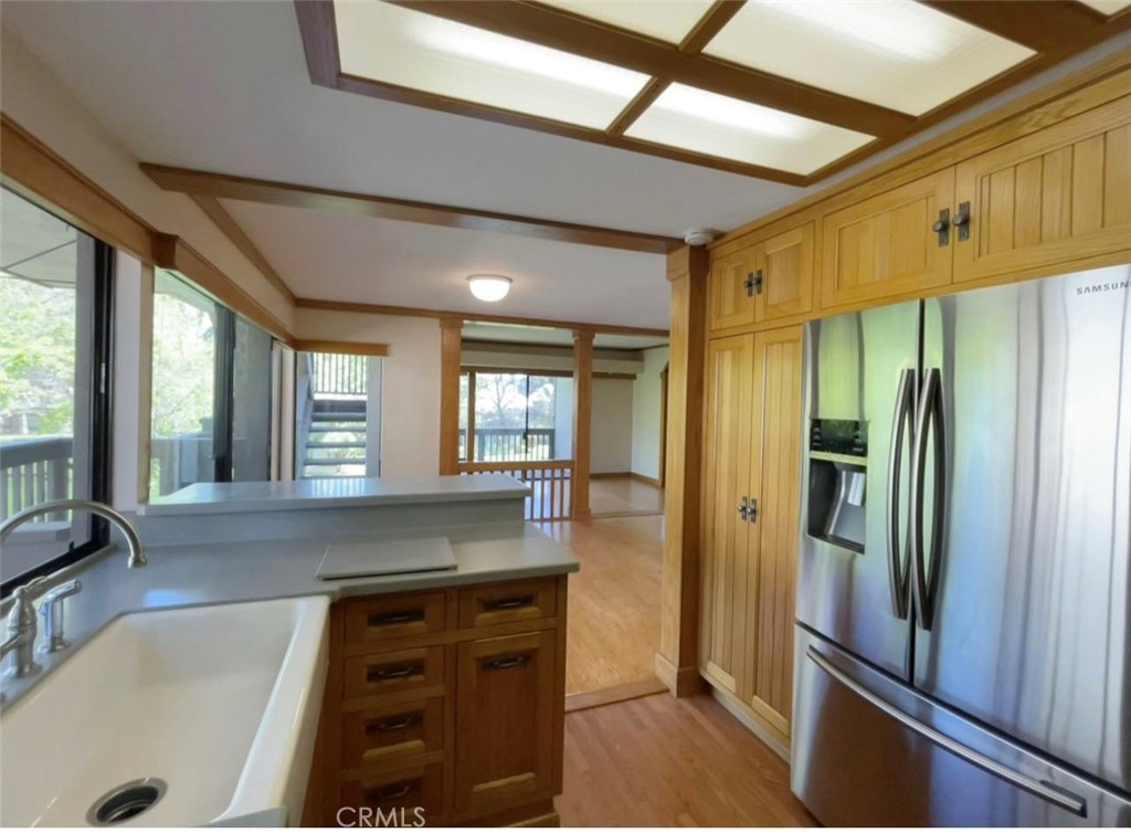 8 Solana, Unit 36 Irvine, CA 92612 - Photo 12 of 22 a kitchen with refrigerator a sink and cabinets