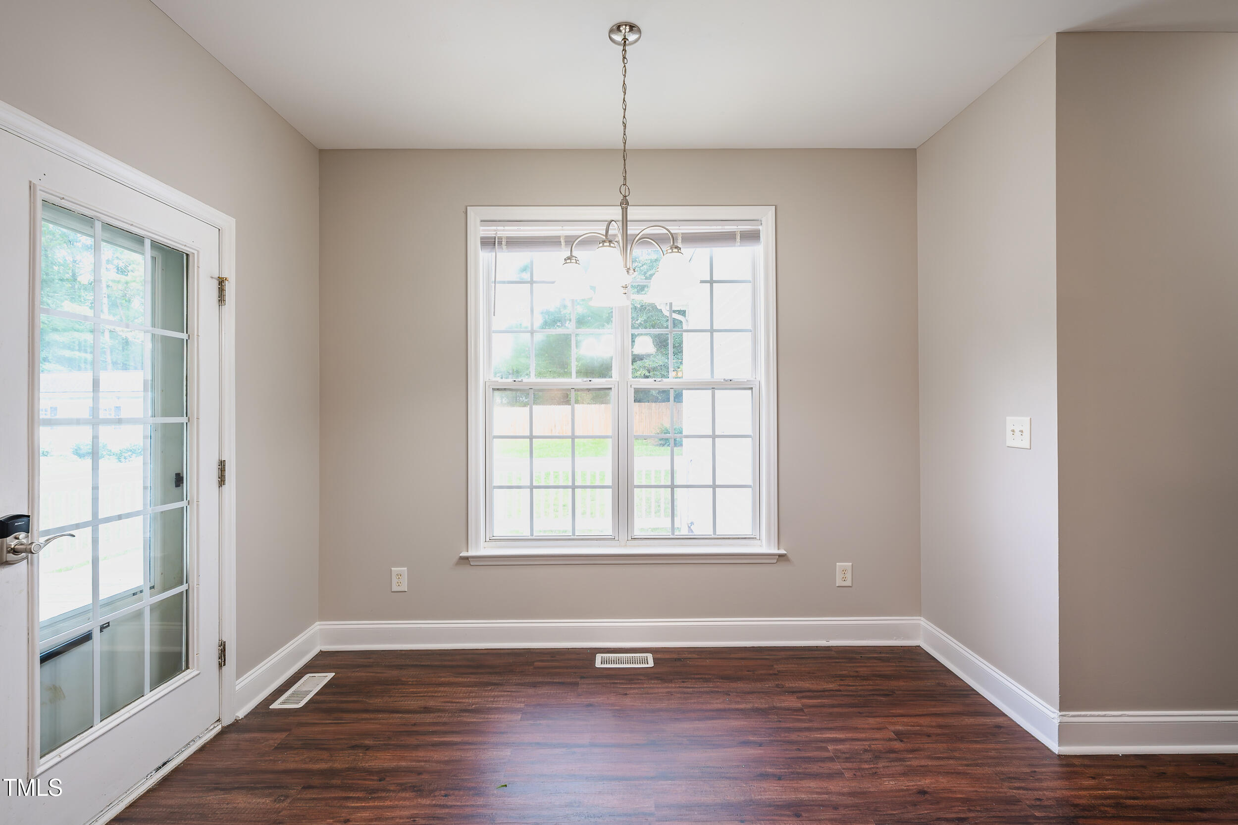 2430 Josephine Road Garner, NC 27529 - Photo 10 of 48 an empty room with wooden floor and windows
