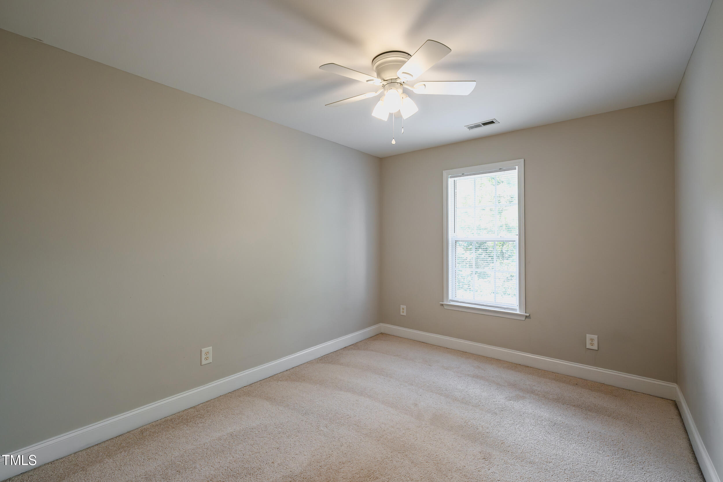 2430 Josephine Road Garner, NC 27529 - Photo 27 of 48 an empty room with windows and chandelier fan